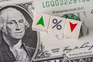 Arrow blocks pointing up and down on top of dollar bill