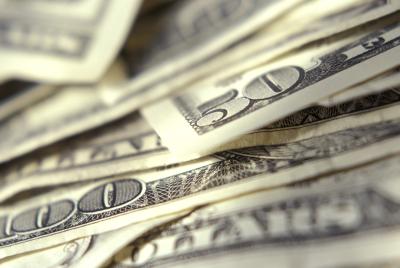Multiple corners of dollar bills in small pile