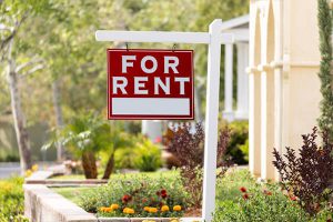 For Rent sign hanging outside a building