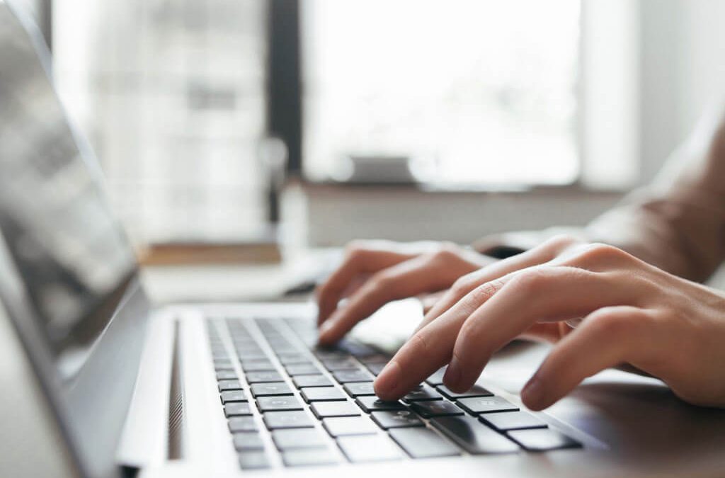 Hands typing on a keyboard