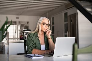 Older woman looking at her laptop