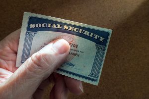 Hand holding a social security card with the numbers covered