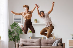 Couple jumping on couch together
