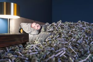 Man sleeping under pile of money