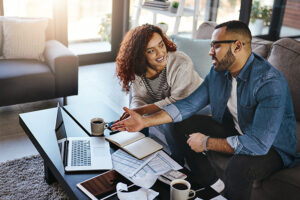 Couple discussing what's on laptop screen together