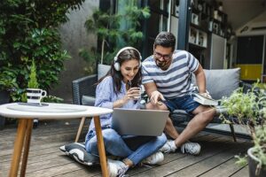 Couple looking at laptop together outdoors
