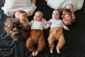 Couple looking at twin babies