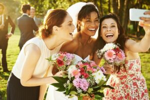 Friends taking selfie with the bride