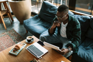 High angle view of a young African American male student in a cafe.