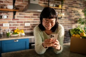 Woman smiling while using smart phone