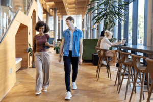 Two business colleagues walking in office lobby