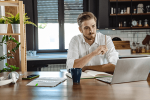 Young man analyzes the performance of his business in turbulent economic times.