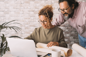 Couple of worker busy in home office alternative workplace with small business job activity together. People work and use computer indoor.