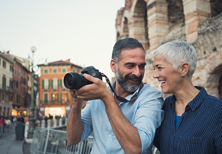 Couple on vacation holding camera