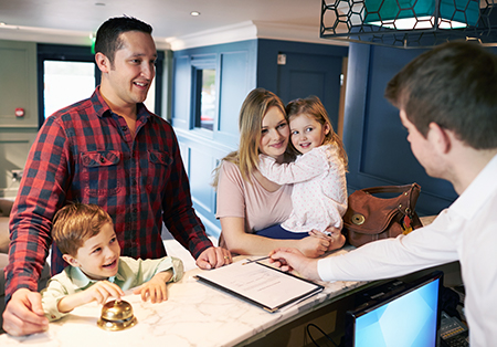 family checking into a hotel