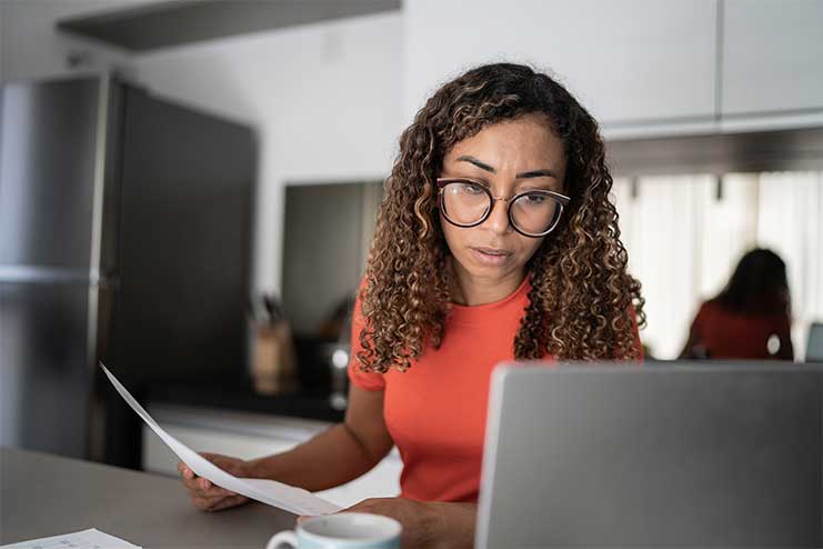 Woman looking stressed in front of her laptop